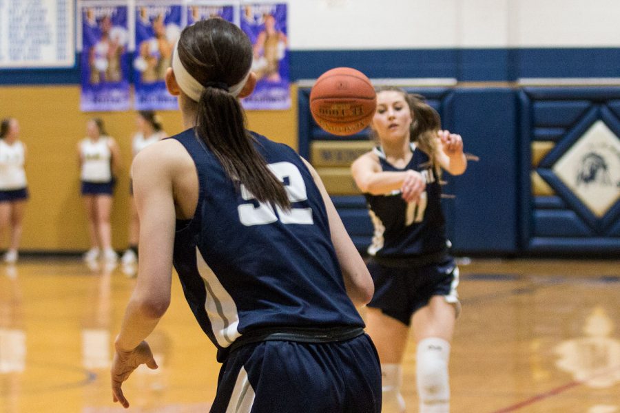 Junior Gracie Stugart passes the ball to sophomore Trinity Matthews in their game against the Holt Indians. The Spartans defeated the Indians and since have also taken down the Francis Howell Vikings. 