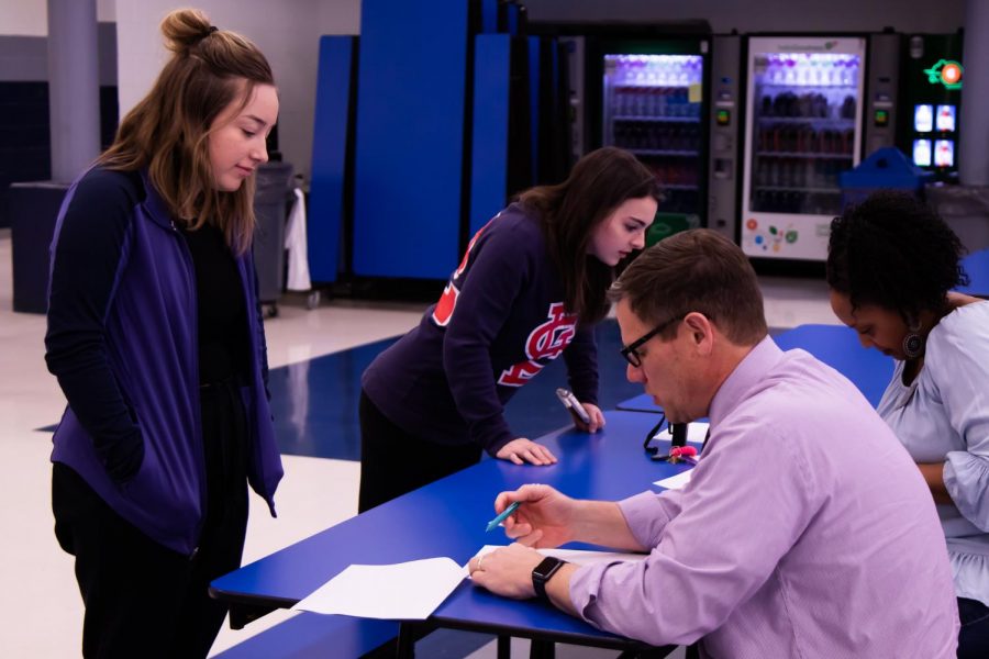 On Wednesday, March 11, Assistant Principal Dave Stofer takes a students name as she provides him with information about her access to technology at home. The district surveyed the entire student population to see who would need help in staying connected to their school in case of school closings due to the COVID-19 outbreak.