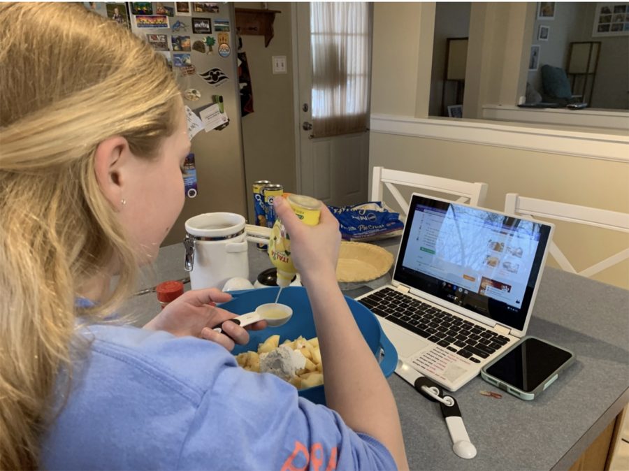 Emma Eiswirth puts the finishing touches on her lunchtime cheese quesadilla while also vlogging about it. 