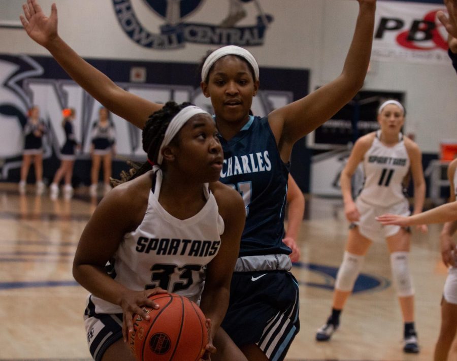 Senior Azaria Hulbert makes a strong drive to the basket during the St. Charles game on Feb. 25. Hulbert said that We had a great season, we worked really hard over the off season, and in season, and its really payed off. 
