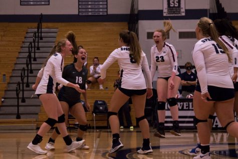 Senior Emma Hultz goes to celebrate a point with her teammates. The team makes sure to keep a positive attitude after each point to encourage perseverance despite tough competition.