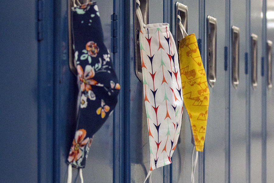 Face masks hang from lockers in the hallways. Masks are the primary way to stop the spread of COVID-19, but when there are positives, its the job of building COVID Coordinator Andy Downs to trace possible contacts.