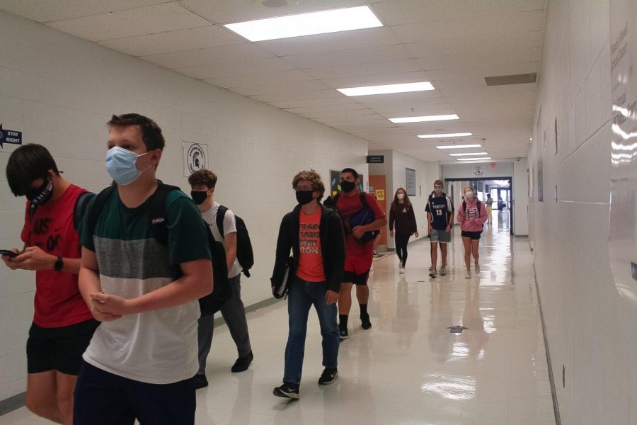 Students+walk+the+halls+with+masks+on+as+everyone+adjusts+to+the+new+reality+at+Central.+