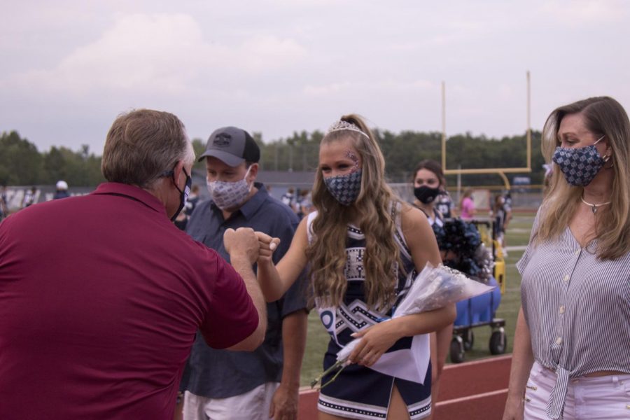 Senior+Shaffer+Brown+fist+bumps+Dr.+Arnel+at+Senior+Night+upon+receiving+her+award.+Precautions+such+as+mask-wearing+have+been+taken+to+keep+students%2C+coaches%2C+and+spectators+at+sporting+events+safe.