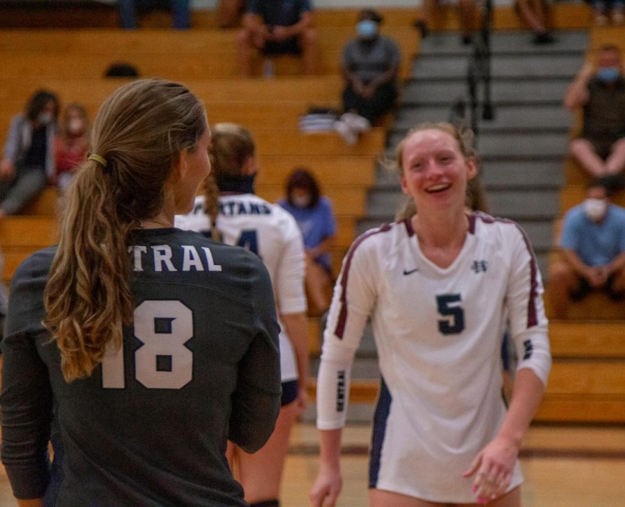 Senior Emma Hultz smiles after a a successful play with her libero, despite the fact that the ladies lost this game 3-1.
