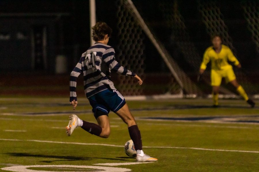 Junior Josiah Gould dribbles before scoring a goal at a previous game. Gould achieved a hat trick at the Oct. 13 game.