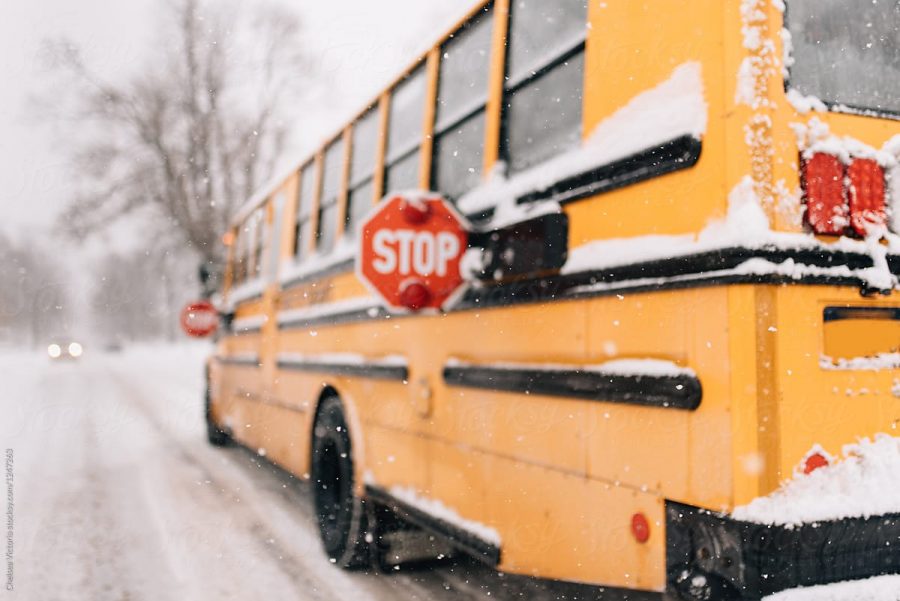 A school bus braves an icy terrain in spite of the dangerous nature of the cold. This buss school made the risky decision to conduct school as usual.