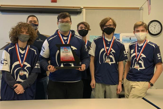 The players pose with the evidence of their championship hanging around their necks. 
Left to right stands Ethan Montgomery, Mr. Kris Miller, Cooper Raubach, Austin King, Zach Buchholz and Tyler Belina. Players not pictured are Ethan Mitchell, Josh Green, Alex Keagy, Gideon Masters, and Caelen Hellmann. 
