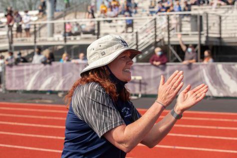 Coach Baize cheering on her long distance athletes