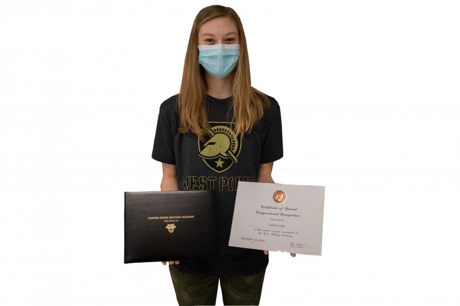 Lauren Guth poses with her Congressional Nomiation certifcate and acceptance booklet. Guth went through a multitudinous process composed of essay-writing and interviews in order to get accepted by West Point Academy, where she plans to attend in order to serve her country and earn a degree. 