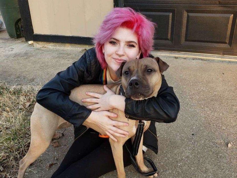 A MEDICAL LIFE-LINE: E Lanterman smiles as they hold their new service dog, Piper. For them, a service dog aids in supporting mental health and comfort. 