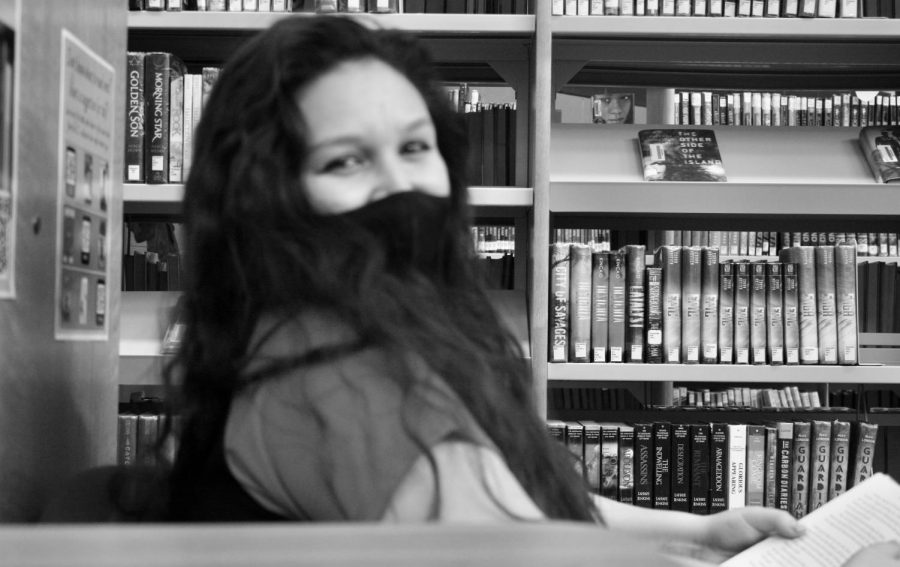 Halie Young is laughing while posing for the camera in the library on April 13, 2021.