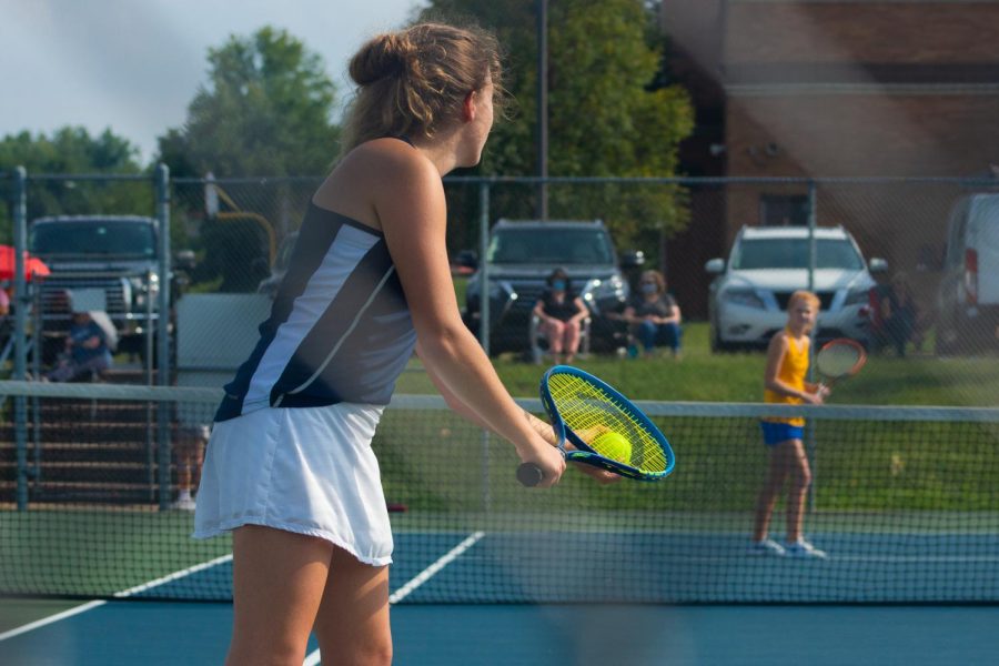 Senior Erin Reitz steadies her gaze before serving against her Francis Howell opponent. This match was a turning point for the team this season, according to Reitz.