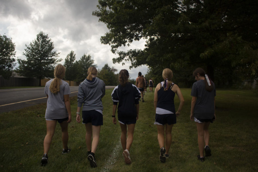 A few JV Girls members walk together behind the rest of the team.
