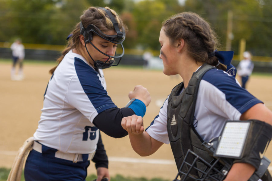 Senior Kennedy Jensen and sophomore Phoebe Miller bumping elbows during the state quarterfinal game, which was suspended after 11 innings with the score even at two. The girls softball team is a well oiled machine who are ready to continue in tonights game. 