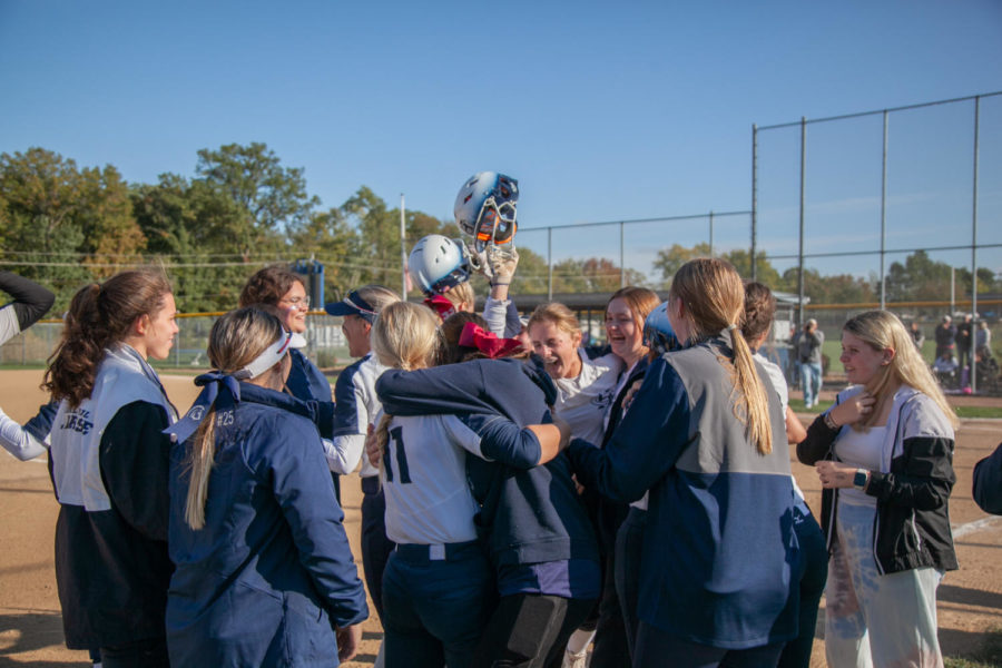 The girls softball team celebrates with their friends and family after winning against Troy. The game was hard fought and the win was celebrated even harder. 