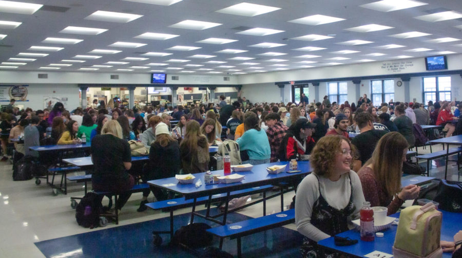  The cafeteria is full of students eating lunch and socializing with one another. The crowdedness of the cafeteria can be overwhelming for some students.