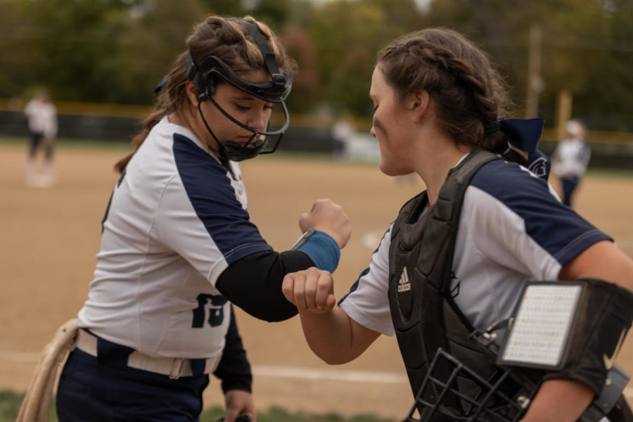 Pitcher catcher duo Jensen and Miller perform their handshake before taking the field.