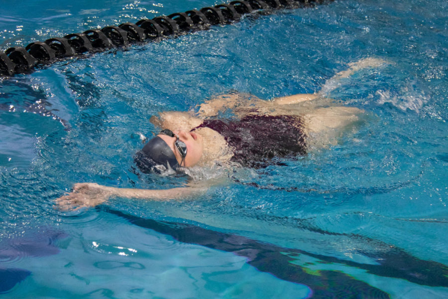 Senior Emma Fox swims the backstroke.