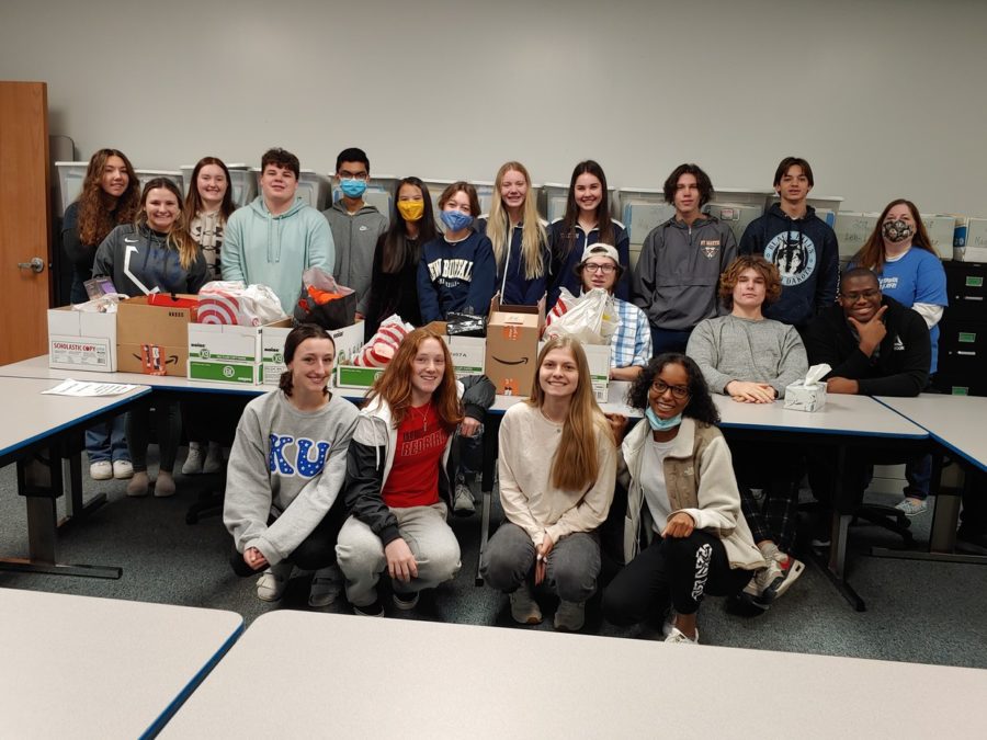 Señora Millers Spanish class surrounds the supplies bought with the money                  collected during the 2021 Adopt-a-Family event. This year the language department collected $4,200 in the month of December for families at FHC. Its nice to be able to help some students feel a little bit more like they have a place and that someone cares and we all know times are hard, Miller said.