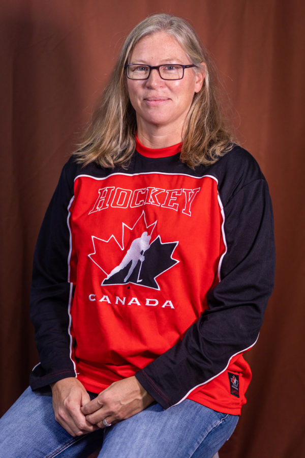 Ms. Barb Riti sits wearing a Canadian hockey jersey. Ms. Riti was originally from Canada but moved to Missouri to pursue a softball scholarship. 