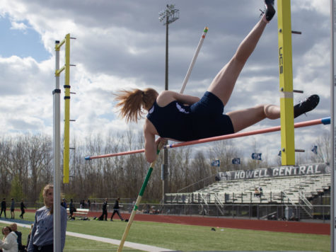 Freshman McKenzie Myers touches the bar in her pole vault.