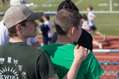 A BROTHERS BOND: Junior Jason Kuhn stands with a supportive hand on his brother freshman Jeremy
Kuhn’s shoulder during a track event. Jeremy has grown up with Jason by his side as a figure of support
in all his endeavors. Jason has always been protective of his younger brother and is willing to go to
great lengths to ensure his brother is safe, comfortable, and happy.