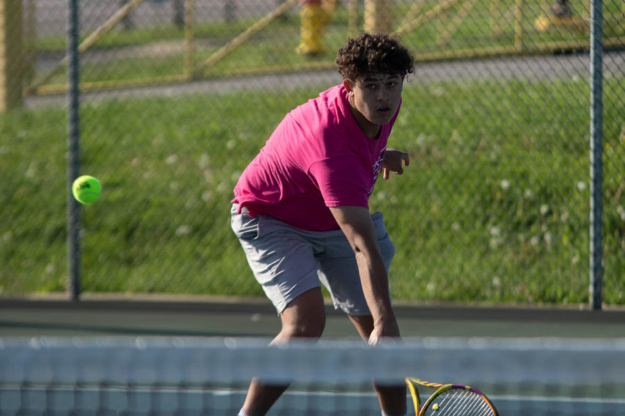 Junior Christian Padilla hits the tennis ball.