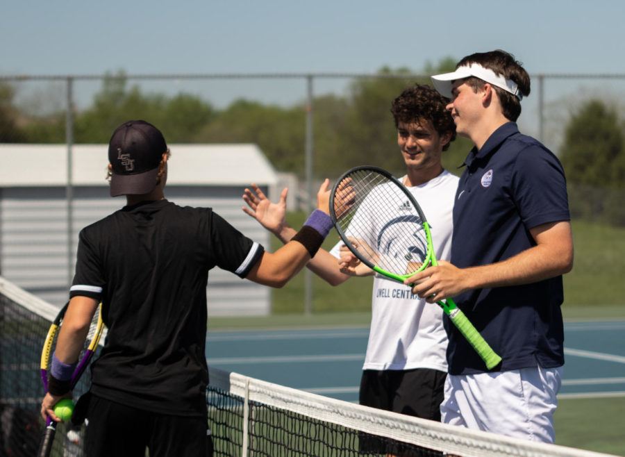 Juniors Tanner Jones and Noah Garthe shake hands with their opponent after the match.