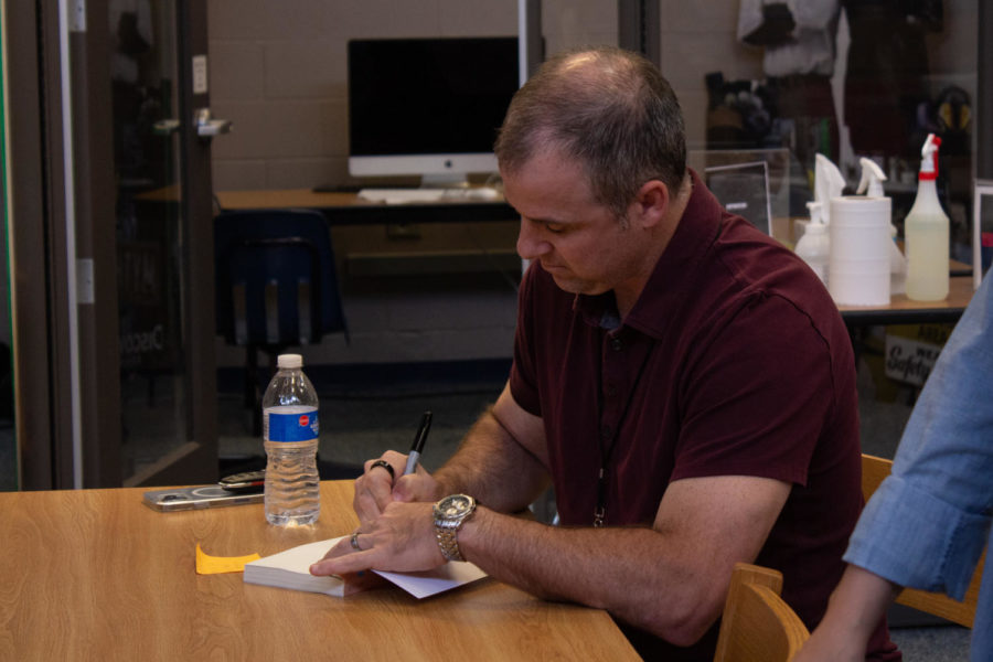 Fred Venturini signs his book for a student.