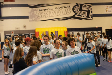 FHC students gather in the gym for Arete Field Day, waiting in line for one of the inflatable attractions. 