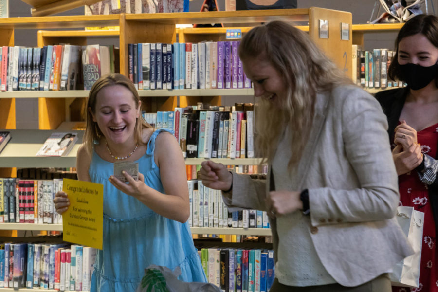 Senior Sarah Percy laughs as she receives the Curious George Award from Mrs. LaMartina.