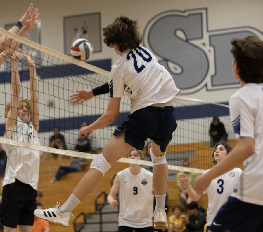 Determined Drives: Senior Ian Johnson spikes the ball to the opposing team, winning a point for the team. 
