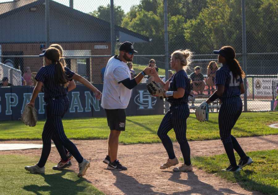 Sarah Hoshaw fist bumping her coach to come in and hit.