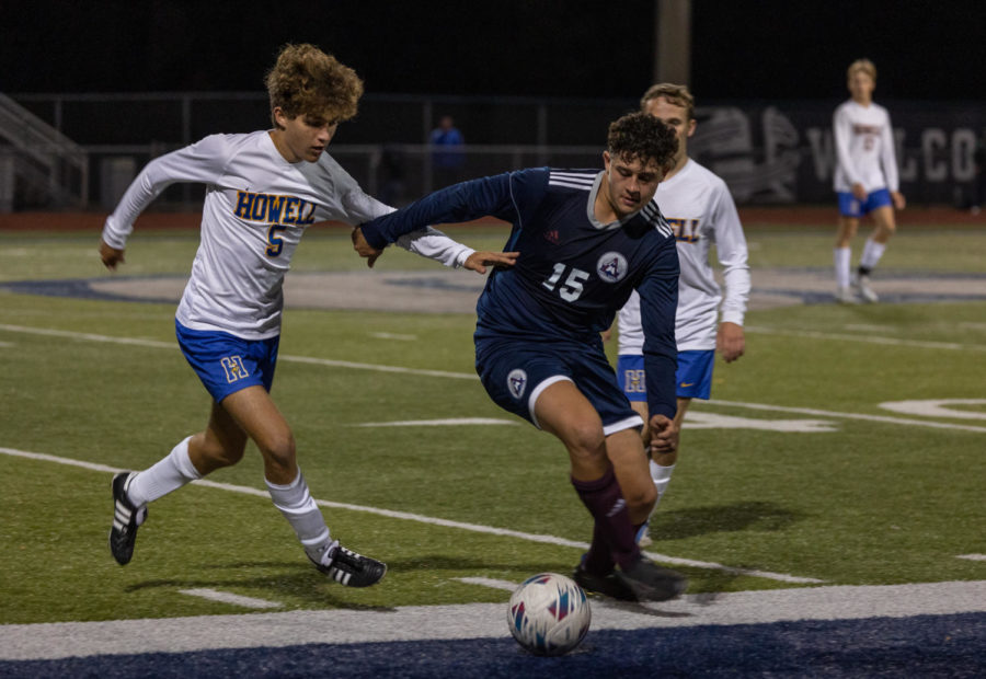 Cristian Padilla trying to block the ball from a Howell player.