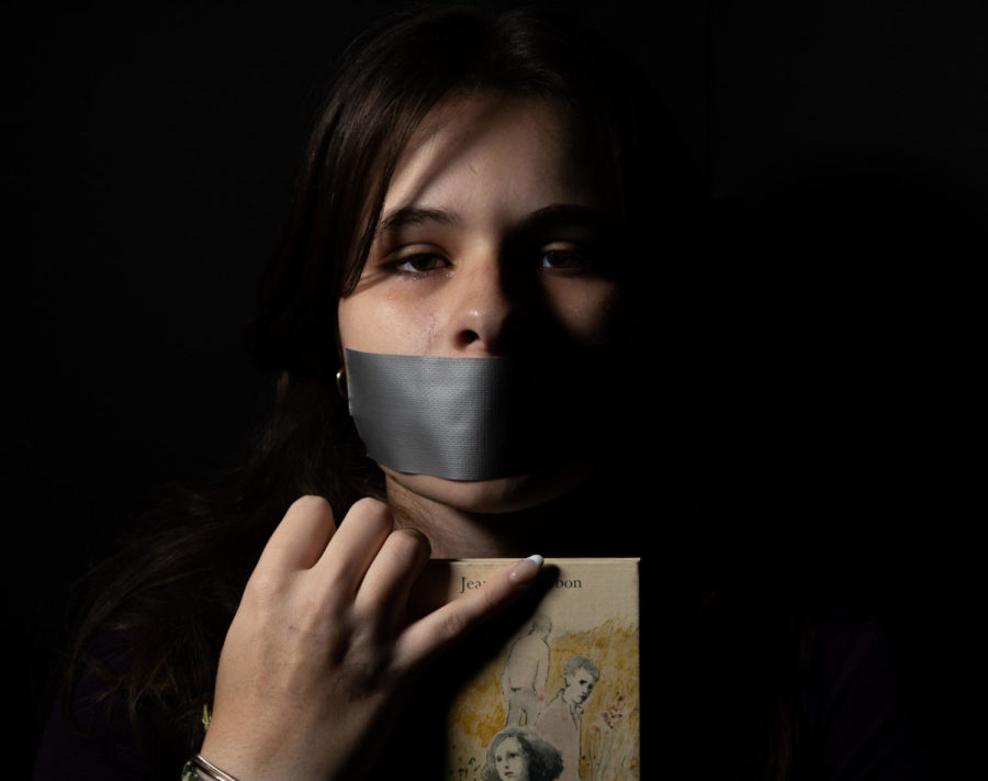 Cordelia+Kraft+clutches+book+while+crying+after+hearing+about+SB+775.+She+duct+tapes+her+mouth+to+represent+the+silencing+that+is+occurring.