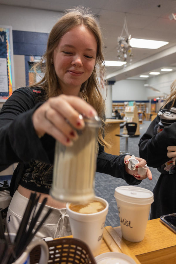 Sophomore Analise Biebel reaches for creamer. 