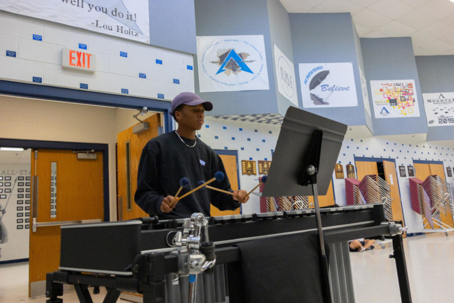 Holding his mallets at the read and focused position, senior Michael Harris stands ready to play in fifth hour Jazz Band. The members of this class meet with professional musician Matt McKeever a couple of times per month to help improve their musicianship and encourage them to take on more difficult  piece of music.