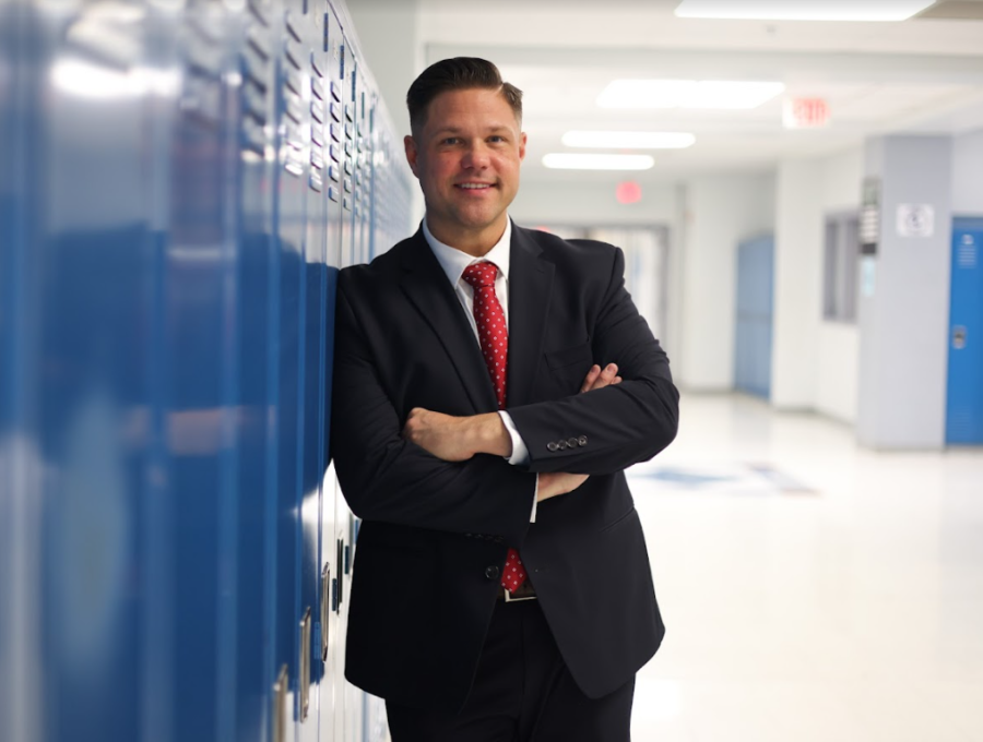Superintendent Dr. Roumpos poses infront of some lockers. Since taking over as Superintendent, Dr. Roumpos has made it his top priority to support staff and students and change the way we operate as a school. Photo courtesy of the districts website. 