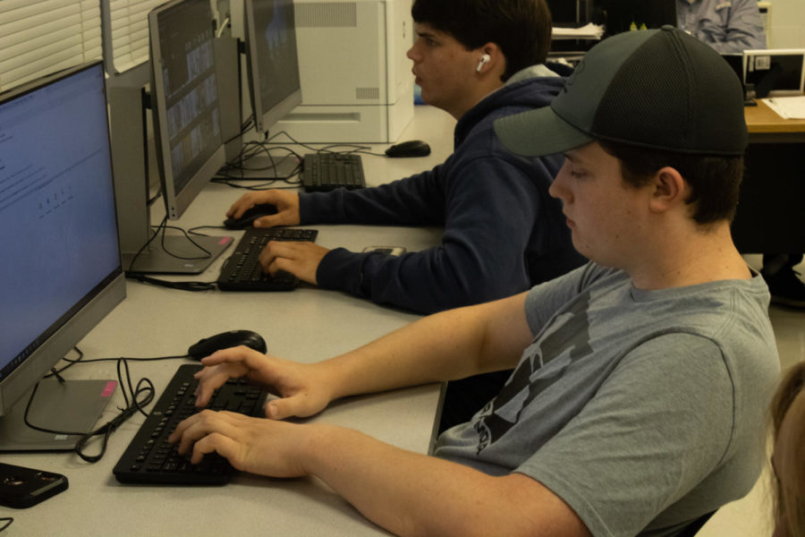 Working on an assignment in Business Entrepreneurship, senior Jacob Dupre completes classwork for Mrs. Shannon Carlson’s class. Dupre’s job at Home Depot has exposed him to some of difficulties teen members of the work force experience, such as understaffing and new hires being paid more than existing employees.