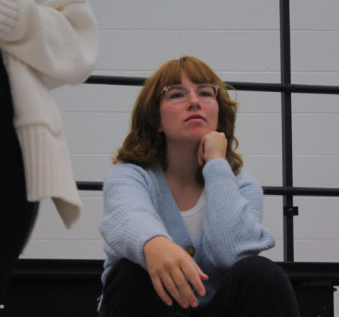Senior Sammi Routh sits and contemplates her part of the song while another section learns their part.