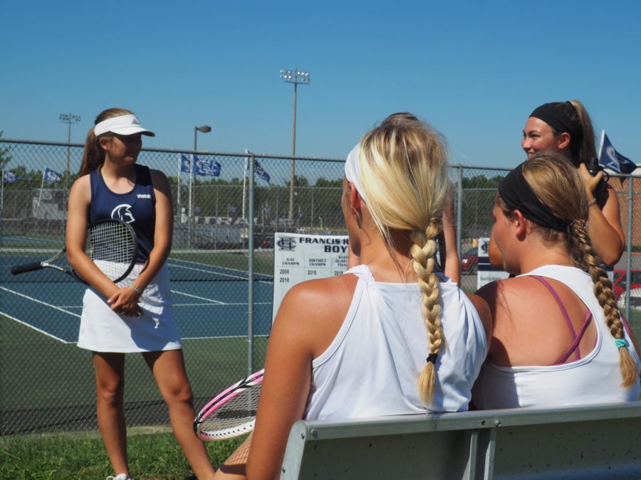 Teammates talk before the game against Holt