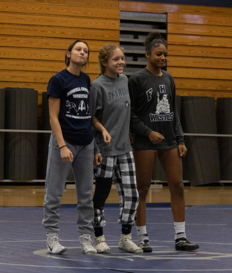 Sophia Miller, Kailey Benson, and Nevaeh Smith link arms proudly as their coach announced their different titles.