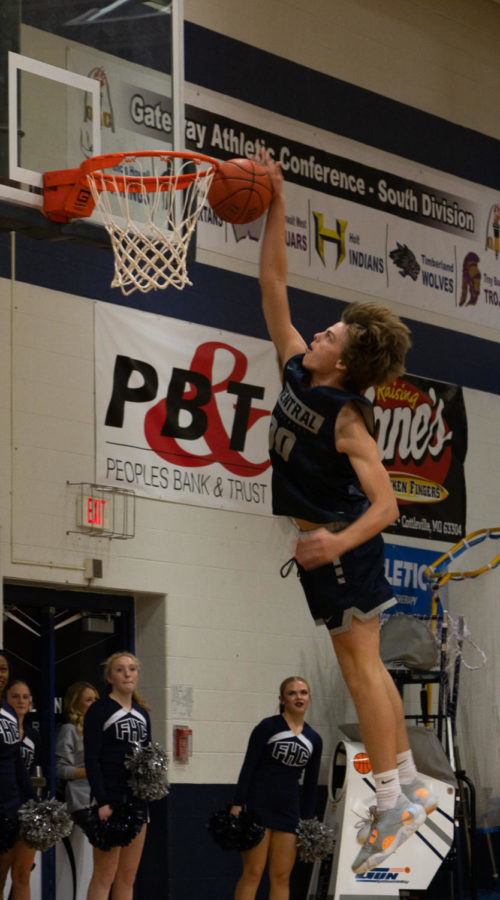 Junior Nate Rush tries to dunk during basketballs warmups.