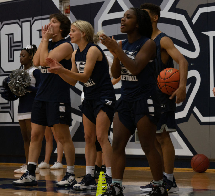 Girls basketball teammates cheer on their team.
