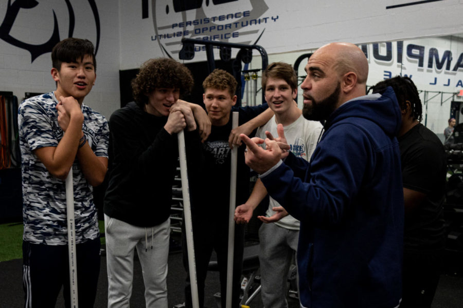 Coach Michael Bunton speaks to students during his sixth hour Advanced Weight Training class. While Coach Bunton gives his students respect from the start, he expects them to return it to him with hard work and good behavior. 