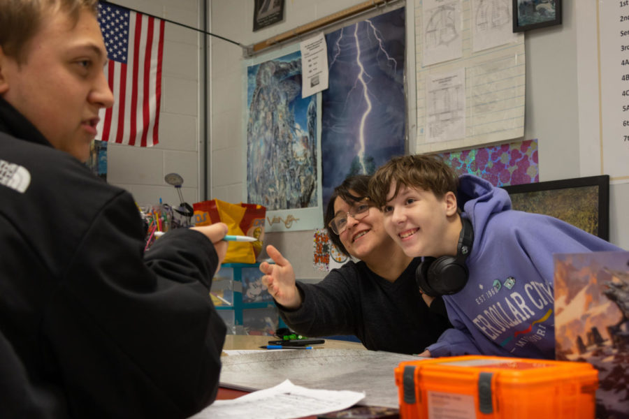 Brynn Bollinger and Aster Johnson, both freshmen, react to something Kaden Bollinger said during the Games Club meeting on Dec. 12 in Mrs. Kim Okai's room after school. The club usually plays "Dungeons & Dragons" but also plays other role-playing games. 