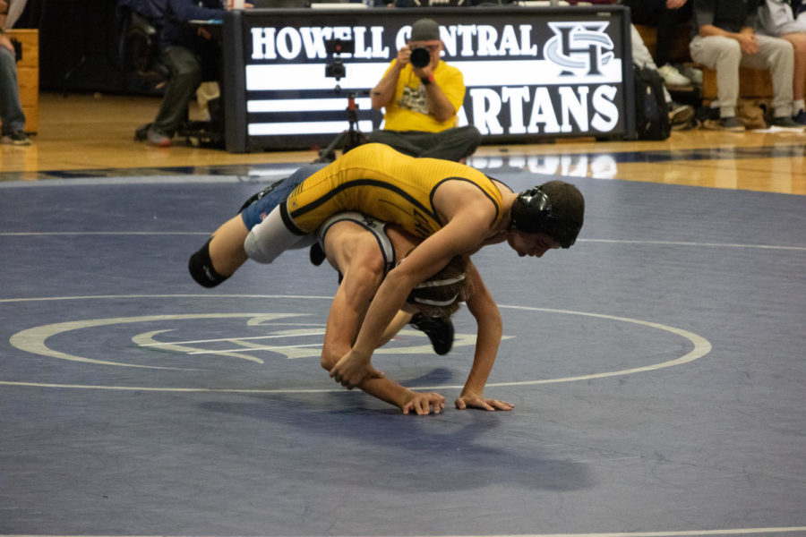 Junior Dylan Myers while flipping his opponent in order to pin him.