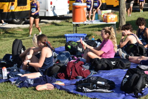 Reese McDevitt puts on her spikes to prepare for her race.
