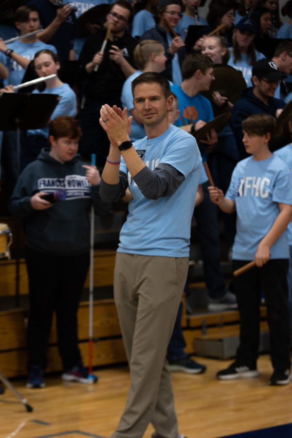 Band instructor and A Band director Mr. Nathan Griffin applauds as the basketball game goes on. His pride in both the team and his band showed while he encouraged more spirit.